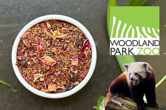 Tea blend in a white bowl with a red panda and Woodland Park Zoo logo in the background