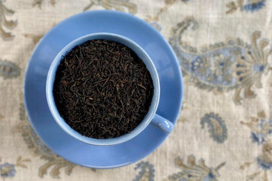 teacup full of pure black tea leaf