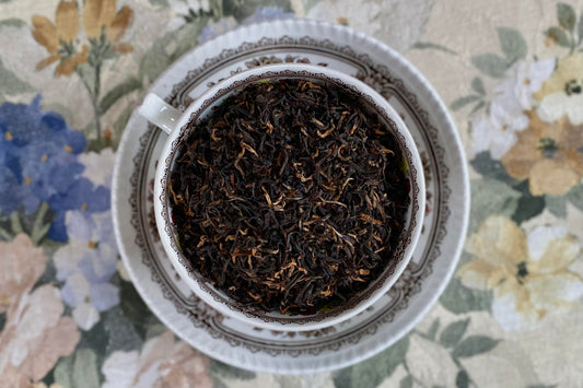 teacup full of black tea with golden tips