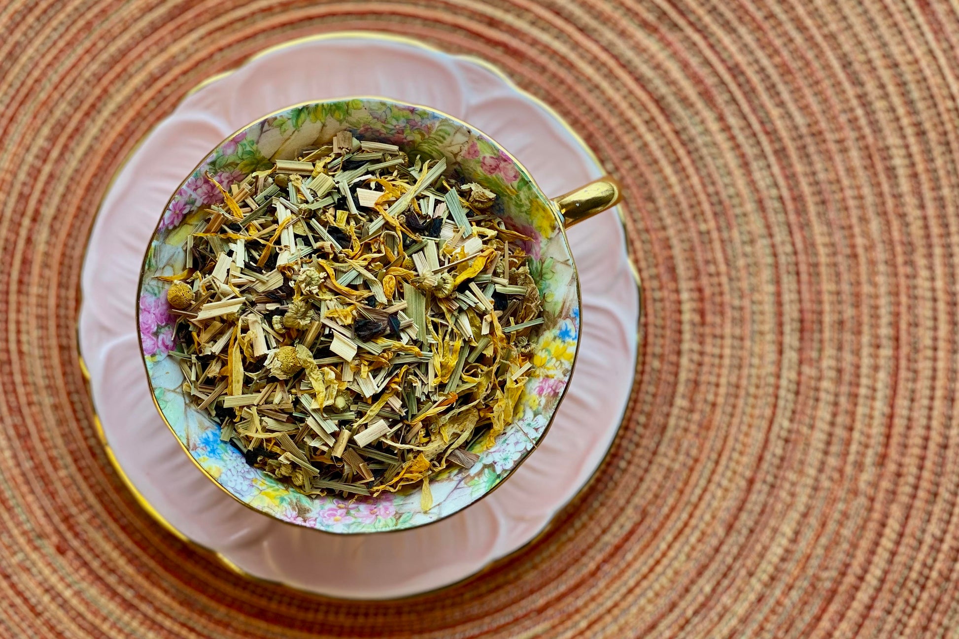 Teacup full of flowers and lemongrass