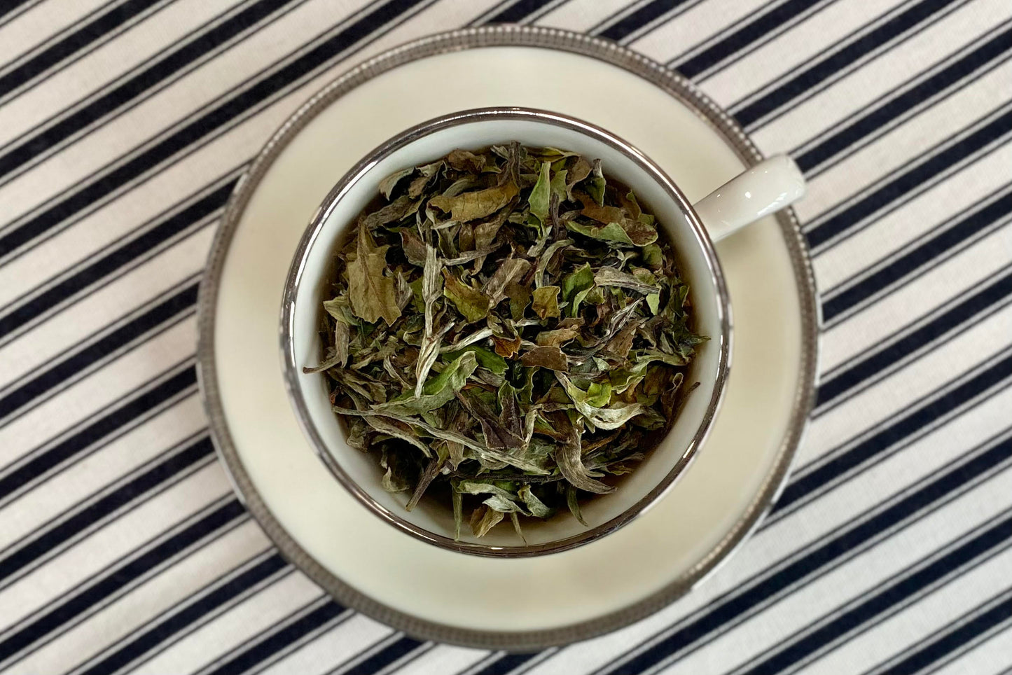 teacup full of white tea leaf