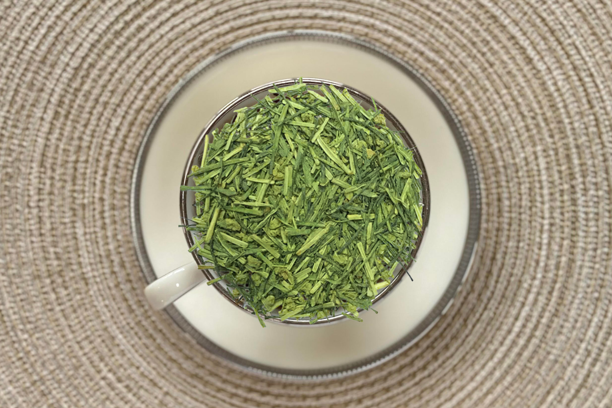 Teacup full of bright green matcha-dusted tea stems