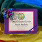 Purple box with rainbow glitter ribbon labeled "Decaf Slutty Little Fruit Basket"