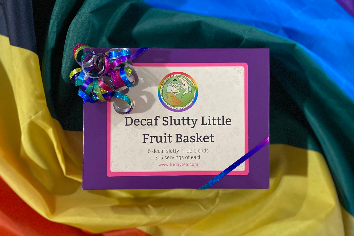 Purple box with rainbow glitter ribbon labeled "Decaf Slutty Little Fruit Basket"