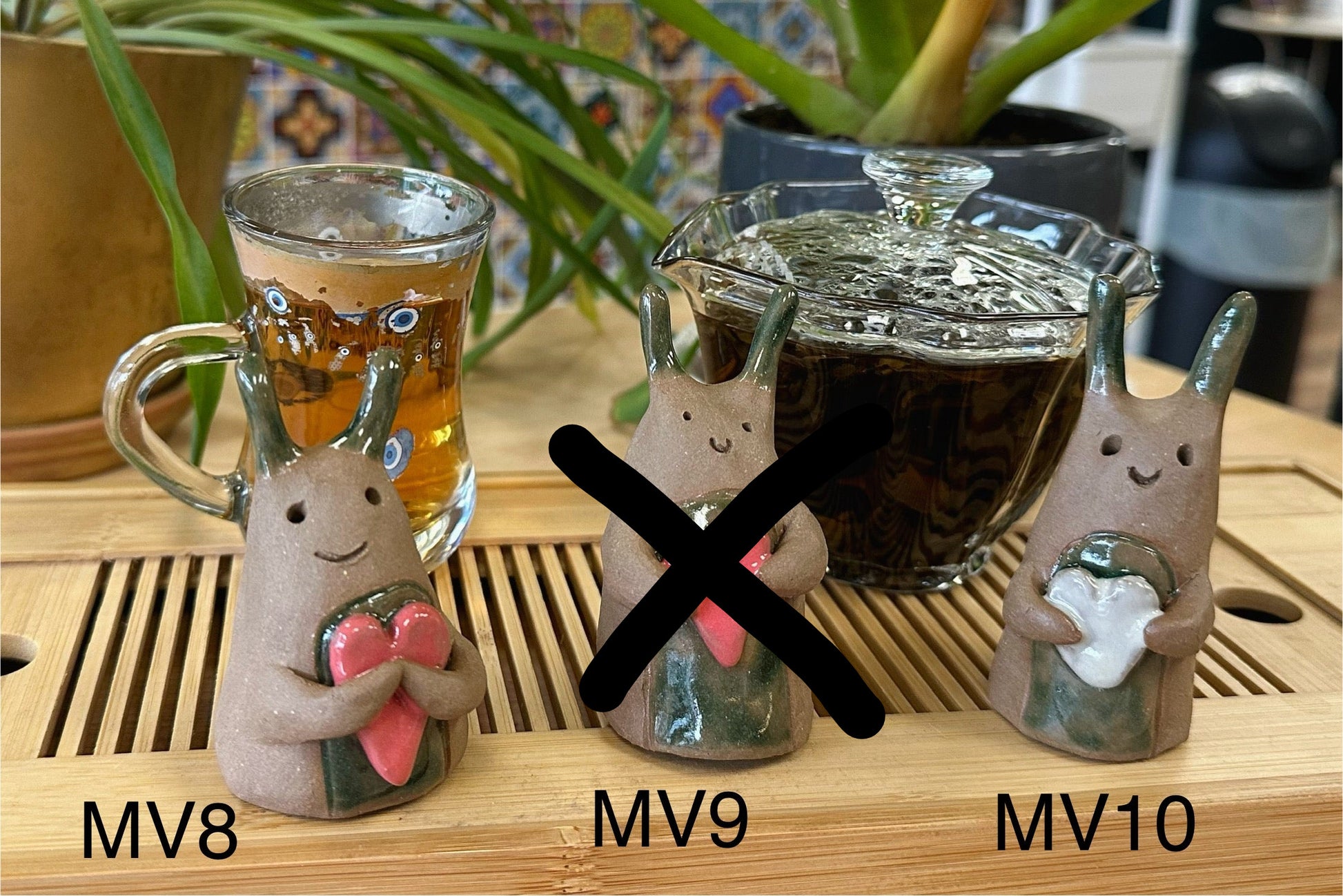 Four slug-type tea pets with hearts numbered MV8-MV10