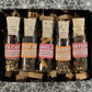 Set of tea samples in small glass jars with labels on a patterned background