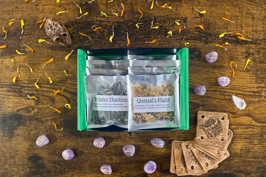 Open box set of mythology teas showing Winter Huntress and Quetzal's Flight on top