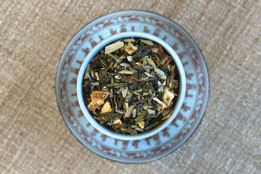 teacup full of green tea, lavender, olive leaf and citrus peel