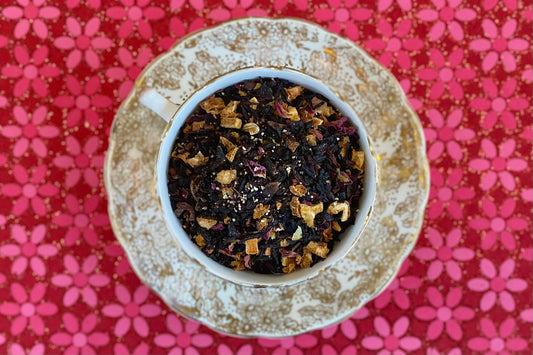 teacup full of hibiscus, citrus peel, rose and honey granule