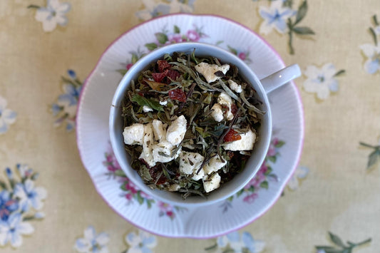 teacup full of white tea with pear and rose hip