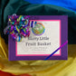 Purple box with rainbow glitter ribbon labeled "Slutty Little Fruit Basket"