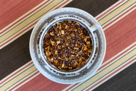 teacup full of cacao nib, orange peel and spices