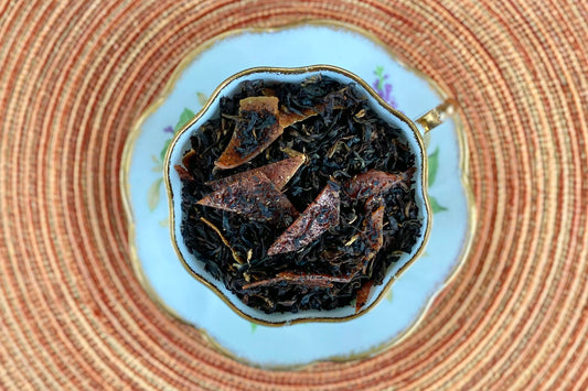 teacup full of black tea and dried guava slivers