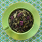 Teacup full of green tea and purple dragonfruit