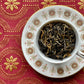teacup full of large half-black, half-gold tea leaves