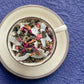 teacup full of rolled oolong tea, rose petal and coconut