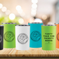 Photo of five colors of travel mug on wooden countertop: black with white tea dragon logo, lime green with black tea dragon logo, white with black tea dragon logo, teal with black tea dragon logo and california poppy orange with black tea dragon logo. Each has text on back reading "tasty teas for thirsty nerds"