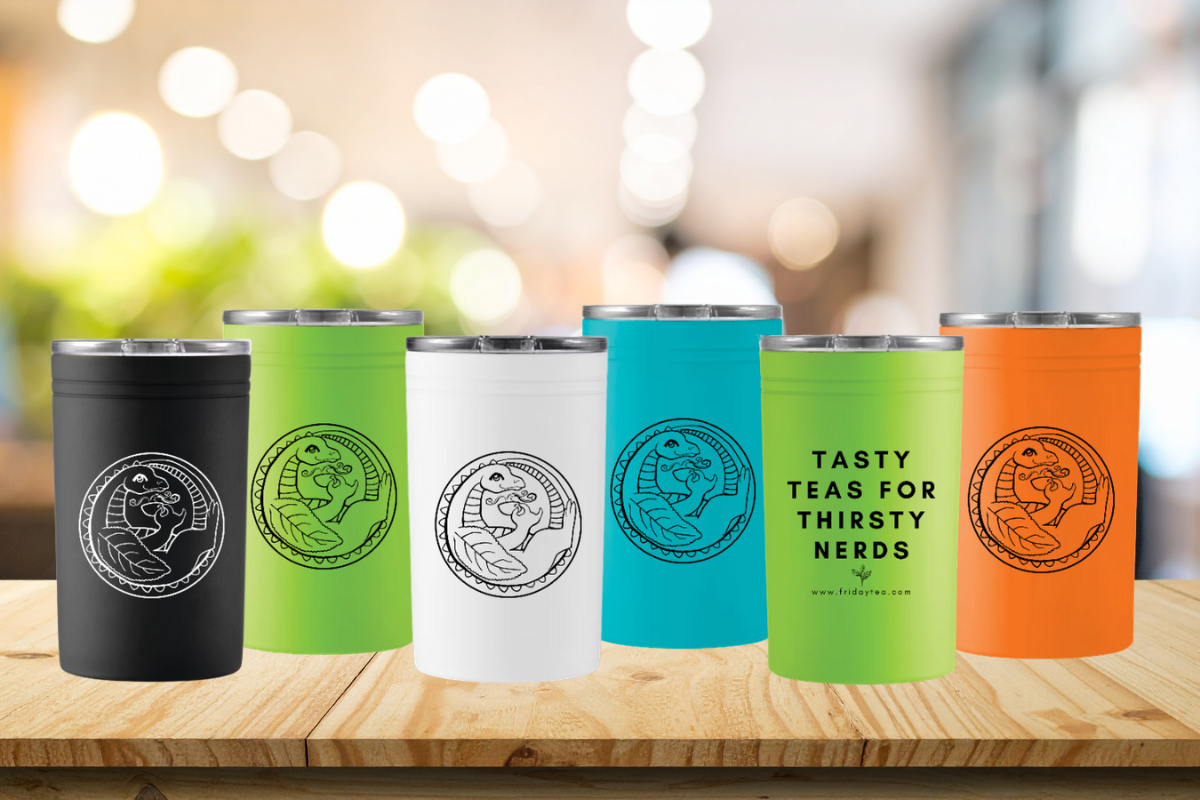 Photo of five colors of travel mug on wooden countertop: black with white tea dragon logo, lime green with black tea dragon logo, white with black tea dragon logo, teal with black tea dragon logo and california poppy orange with black tea dragon logo. Each has text on back reading "tasty teas for thirsty nerds"